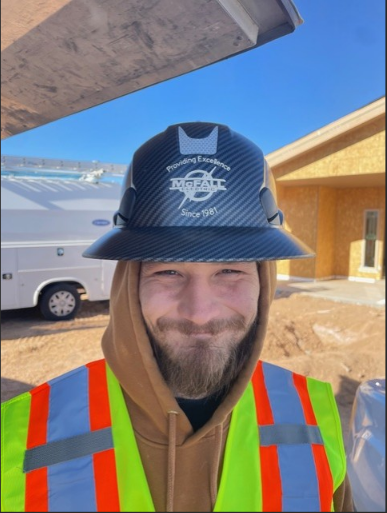 McFall Electric crew member in hard hat and safety vest on job site