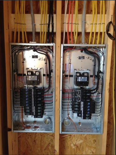 Dual electrical panel rough-in in wood-framed wall